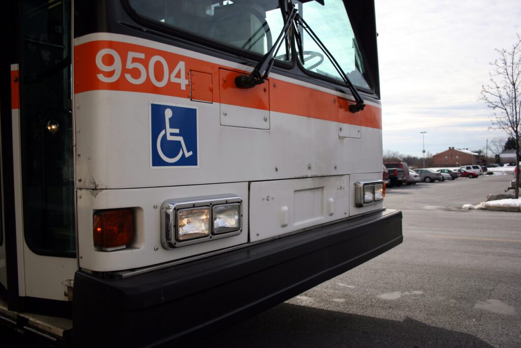 Public bus with Internatinal Symbol of Accessibility on the front.